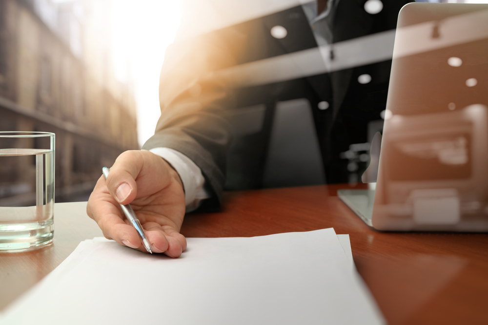 double exposure of businessman or salesman handing over a contract on wooden desk double exposure of businessman or salesman handing over a contract on wooden desk